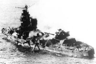In this June, 1942 file photo, a Japanese ship lies low in the water after being bombed by U.S. Naval aircraft during the Battle of Midway in the Northwestern Hawaiian Islands. The Battle of Midway was a major turning point in World War II's Pacific theater. (AP Photo, File)