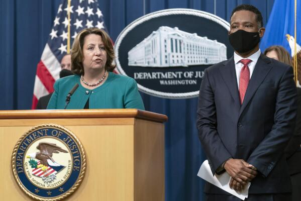 Deputy Attorney General Lisa Monaco, with Assistant Attorney General Kenneth Polite Jr. of the Justice Department's Criminal Division, speaks during a news at the Department of Justice in Washington, Tuesday, Oct. 26, 2021. Law enforcement officials in the U.S. and Europe have arrested 150 people and seized more than $31 million in an international drug trafficking investigation stemming from sales on the darknet. (AP Photo/Manuel Balce Ceneta)