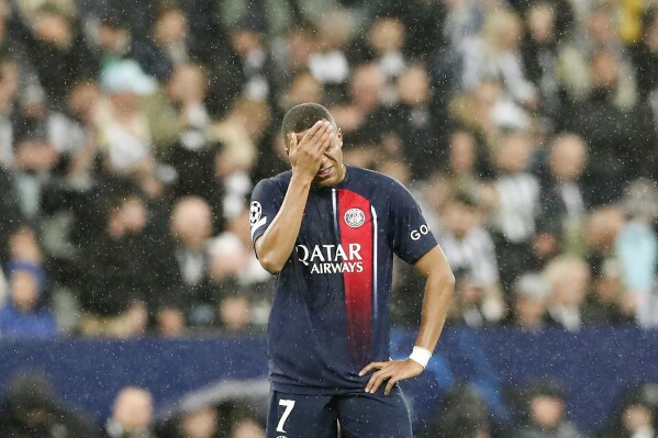 PSG's Kylian Mbappe touches his face during the Champions League group F soccer match between Newcastle and Paris Saint Germain at St. James' Park, Wednesday, Oct. 4, 2023, in Newcastle, England. (AP Photo/Scott Heppell)