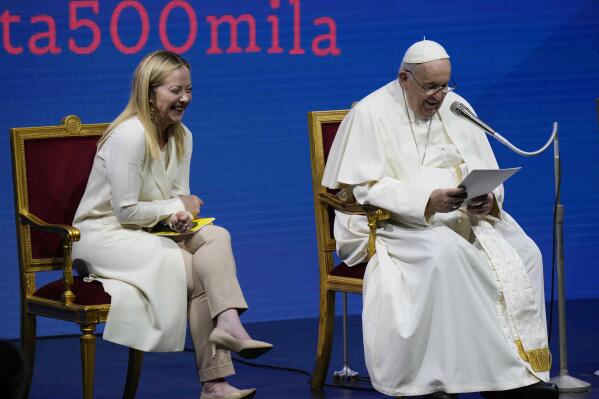 Pope Francis delivers his speech flanked by Italian Premier Giorgia Meloni during a conference on birthrate, at Auditorium della Conciliazione, in Rome, Friday, May 12, 2023. (AP Photo/Alessandra Tarantino)