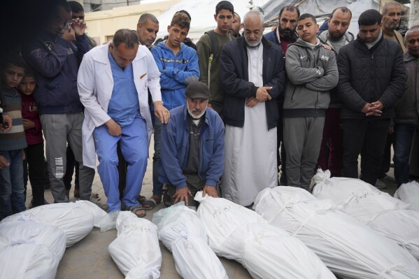 Palestinians mourn their relatives from the Al Kahwaji family killed in the Israeli bombing of the Gaza Strip in Deir al Balah on Monday, Feb. 12, 2024. (AP Photo/Adel Hana)
