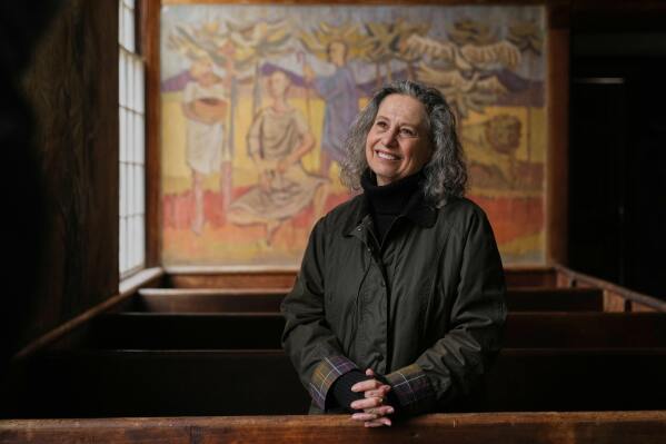 Veronique Plesch, an art professor at Colby College, pauses during a tour of the South Solon Meeting House, Sunday, April 6, 2025, in Solon, Maine. (AP Photo/Robert F. Bukaty)