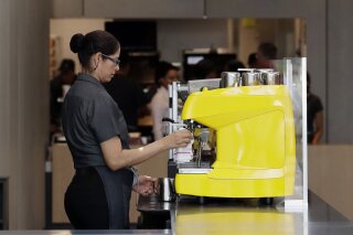 In this Aug. 8, 2018, photo an employee works at a McDonald's restaurant in Chicago. The Trump administration has issued a rule that will make overtime pay available to 1.3 million additional worke...