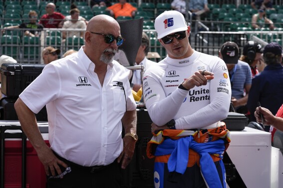 Graham Rahal, right, talks with his dad, Bobby Rahal, during qualifications for the Indianapolis 500 auto race at Indianapolis Motor Speedway, Saturday, May 18, 2024, in Indianapolis. (AP Photo/Darron Cummings)