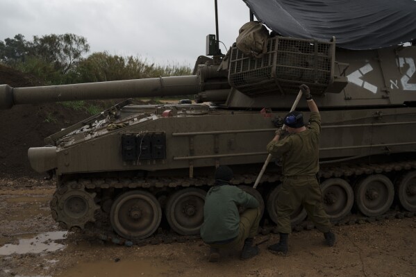 Israeli soldiers fix tracks near the border with Lebanon, in northern Israel, Thursday, Jan. 11, 2024. (AP Photo/Leo Correa)