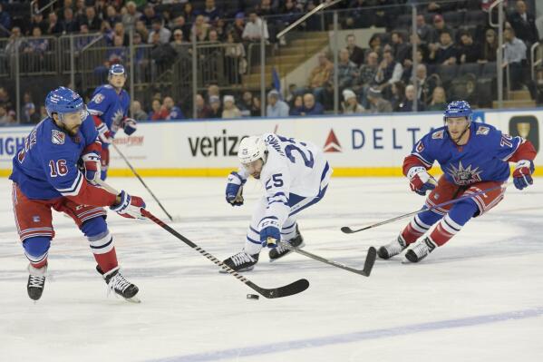 Toronto Maple Leafs defenseman Conor Timmins (25) skates against New York Rangers center Vincent Trocheck (16) and ph76n/ during the first period of an NHL hockey game, Thursday, Dec. 15, 2022, at Madison Square Garden in New York. (AP Photo/Mary Altaffer)
