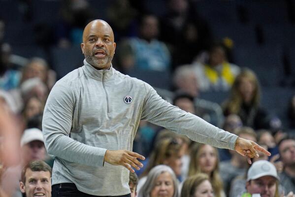 Washington Wizards head coach Wes Unseld Jr. gives direction to his team during the first half of an NBA basketball game against the Charlotte Hornets on Sunday, April 10, 2022, in Charlotte, N.C. (AP Photo/Rusty Jones)