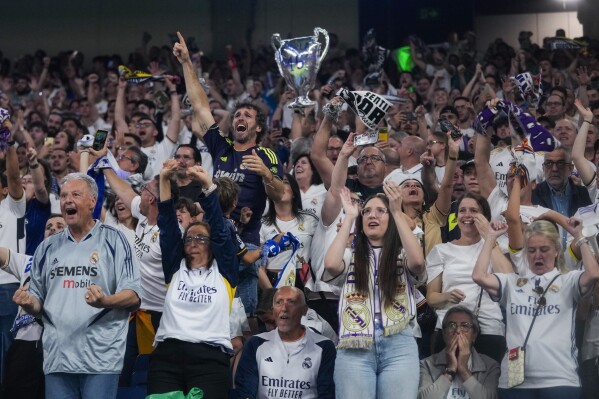 Real Madrid fans celebrate their team goal as they wat the Champions League final soccer match between Real Madrid and Borussia Dortmund at Santiago Bernabeu stadium, in Madrid, Spain, Saturday, June 1, 2024. (AP Photo/Paul White)