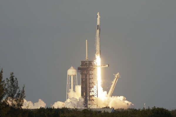 A SpaceX Falcon 9 rocket with a crew of four aboard the Crew Dragon spacecraft lifts off on a mission to the International Space Station from pad 39A at the Kennedy Space Center in Cape Canaveral, Fla., Friday, March 14, 2025. (AP Photo/Terry Renna)
