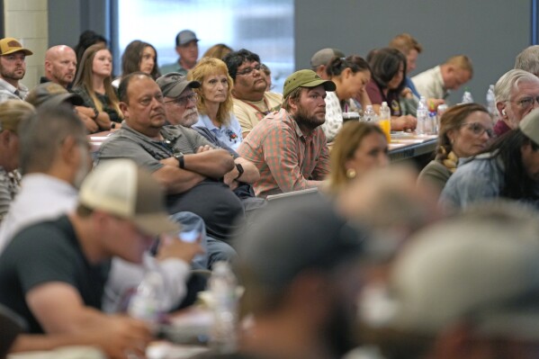 Workers from eastern Utah's oil and gas industry and others attend a Utah Division of Oil, Gas and Mining meeting on July 13, 2023, in Duchesne, Utah. The department convenes regular public meetings to update community members on industry-related news, including the Uinta Basin Railway. (AP Photo/Rick Bowmer)