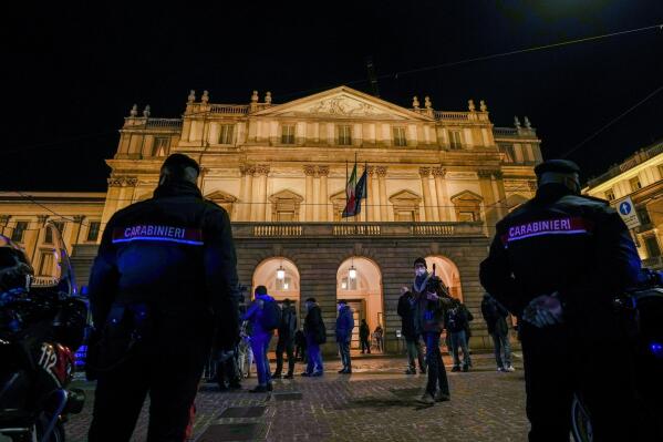 Italian Carabinieri police patrol outside La Scala opera house for the premiere of Verdi's Macbeth in Milan, Italy, Tuesday, Dec. 7, 2021. The Macbeth opens the 2021/2021 lyric season of one of the most storied opera house in the world. (AP Photo/Antonio Calanni)