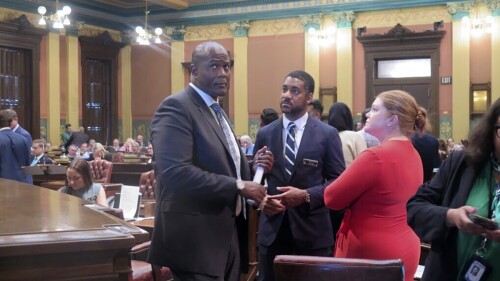 Michigan House Speaker Joe Tate, left, speaks to legislative staff on the House floor as lawmakers work towards completing a state budget ahead of a July 1 deadline, Tuesday, June 27, 2023, in Lansing, Mich. (AP Photo/Joey Cappelletti)