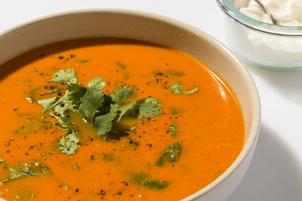 This image released by Milk Street shows a recipe for Indian-style tomato-ginger soup. (Milk Street via AP)