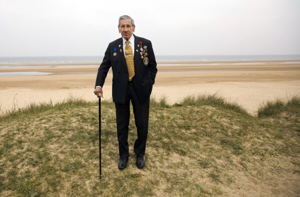 
              World War II and D-Day veteran Charles Norman Shay, from Indian Island, Maine, poses on a dune at Omaha Beach in Saint-Laurent-sur-Mer, Normandy, France, May 1, 2019. Shay was a combat medic on D-Day, assigned to an assault battalion in the first wave of attacks on D-Day, June 6, 1944. (AP Photo/Virginia Mayo)
            