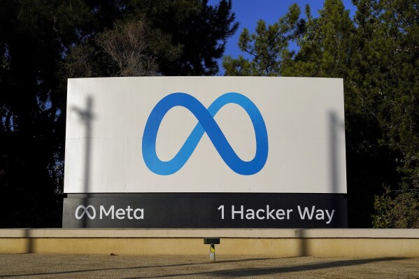 FILE - Meta's logo is seen on a sign at the company's headquarters in Menlo Park, Calif., Nov. 9, 2022. A quasi-independent review board is recommending that Facebook parent company Meta overturn two decisions it made this fall to remove posts “informing the world about human suffering on both sides” of the Israel-Hamas war. (AP Photo/Godofredo A. Vásquez, File)