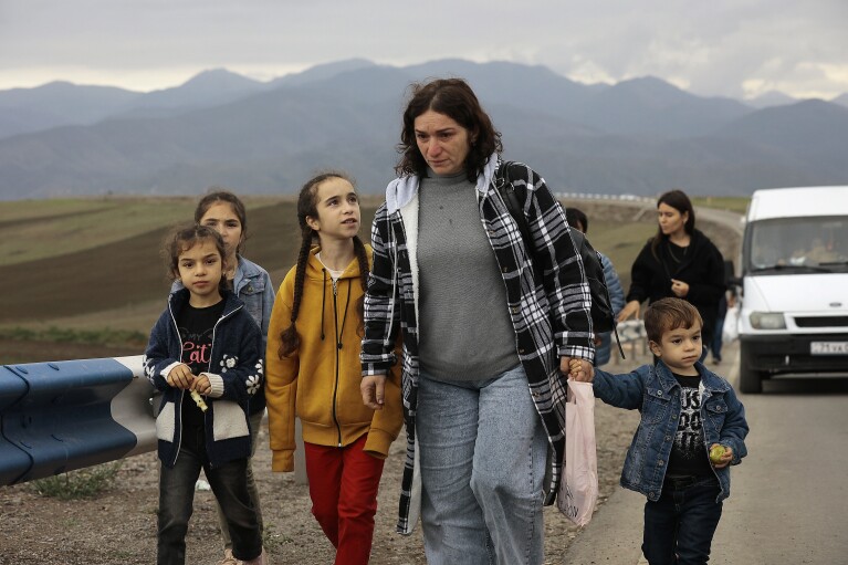 Ethnic Armenians fleeing Nagorno-Karabakh walk on a road to Kornidzor, in Armenia's Syunik region, Tuesday, Sept. 26, 2023. (AP Photo/Vasily Krestyaninov)