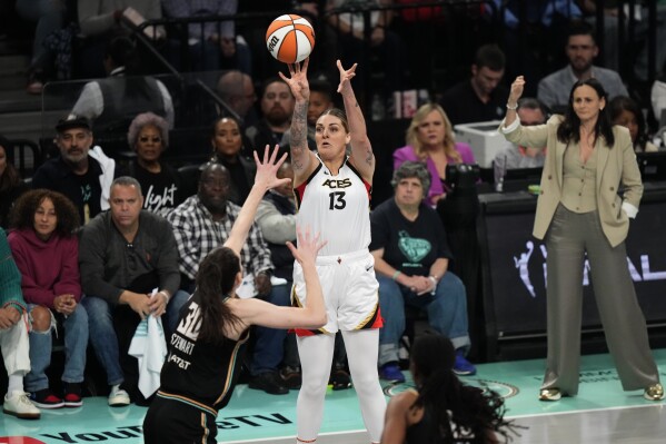 Las Vegas Aces' Cayla George (13) shoots over New York Liberty's Breanna Stewart (30) during the first half in Game 4 of a WNBA basketball final playoff series Wednesday, Oct. 18, 2023, in New York. (AP Photo/Frank Franklin II)