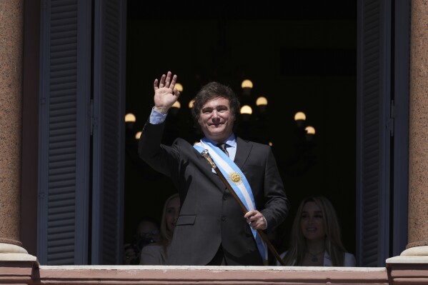 Argentina's newly sworn-in President Javier Milei waves to supporters from the balcony of the government house in Buenos Aires, Argentina, Sunday, Dec. 10, 2023. (AP Photo/Matilde Campodonico)