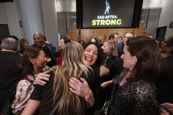 SAG-AFTRA President Fran Drescher, hugs a member of the TV/Theatrical Negotiating Committee member in celebration after a news conference at the SAG-AFTRA offices in Los Angeles on Friday, Nov. 10, 2023. (AP Photo/Richard Vogel)