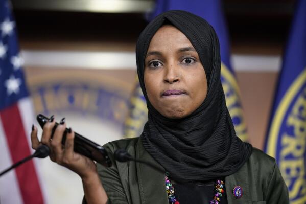 Rep. Ilhan Omar, D-Minn., plays a recording of a death threat left on her voicemail in the wake of anti-Islamic comments made last week by Rep. Lauren Boebert, R-Colo., who likened Omar to a bomb-carrying terrorist, during a news conference at the Capitol in Washington, Tuesday, Nov. 30, 2021. (AP Photo/J. Scott Applewhite)