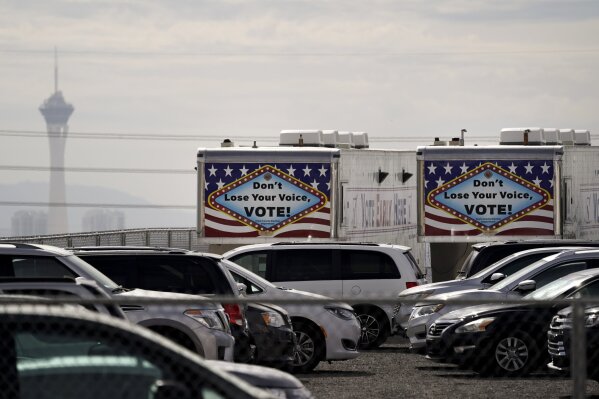 FILE - In this Nov. 6, 2020, file photo, trailers with vote signs are parked in the parking lot of the Clark County Election Department in North Las Vegas. The Nevada Supreme Court made Joe Biden's win in the state official on Tuesday, Nov. 24, 2020, approving the final canvass of the Nov. 3 election.  (AP Photo/Jae C. Hong, File)