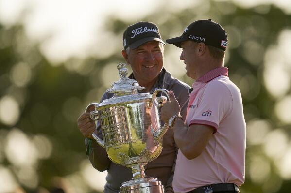 Justin Thomas poses with the Wanamaker Trophy with his dad Mike, after winning the PGA Championship golf tournament in a playoff against Will Zalatoris at Southern Hills Country Club, Sunday, May 22, 2022, in Tulsa, Okla. (AP Photo/Sue Ogrocki)