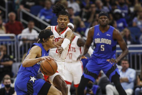 Orlando Magic guard R.J. Hampton, left, drives against Houston Rockets guard Jalen Green, center, as Magic center Mo Bamba, right, looks on during the first half of an NBA basketball game, Friday, Feb. 25, 2022, in Orlando, Fla. (AP Photo/Jacob M. Langston)