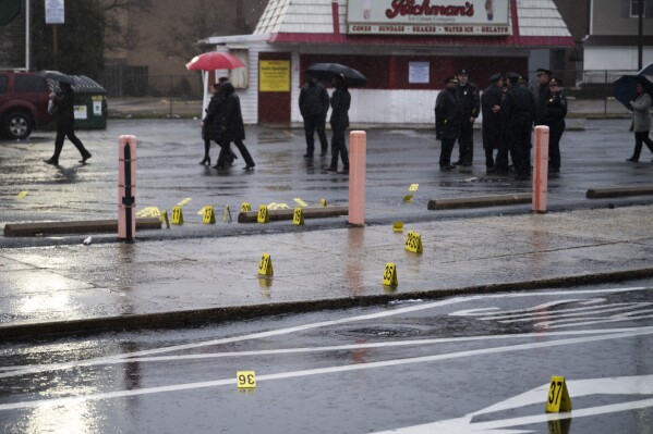 Evidence markers are seen following a shooting in Northeast Philadelphia on Wednesday, March 6, 2024. Four shootings over four days in Philadelphia left three dead and 12 injured, many of them children — violence that put renewed focus on safety within the sprawling mass transit system and gave ammunition to critics of the city's progressive chief prosecutor. (AP Photo/Joe Lamberti)