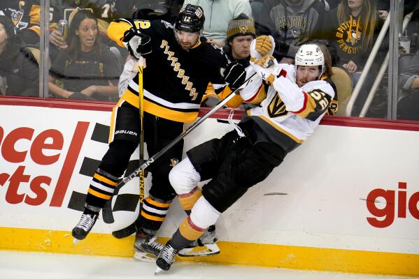 Pittsburgh Penguins' Marcus Pettersson (28) clears Vegas Golden