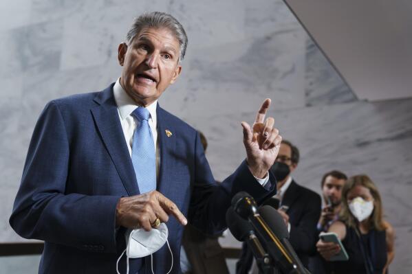 FILE - Sen. Joe Manchin, D-W.Va., talks with reporters as the Capitol in Washington, Aug. 1, 2022. Sen. Susan Collins, R-Maine, and Manchin are making the case for overhauling the 1800s-era Electoral Count Act. The two senators pushed Aug. 3, for quick passage of their bipartisan compromise that would make it harder for a losing candidate to overturn the legitimate results of a presidential election.(AP Photo/J. Scott Applewhite, File)
