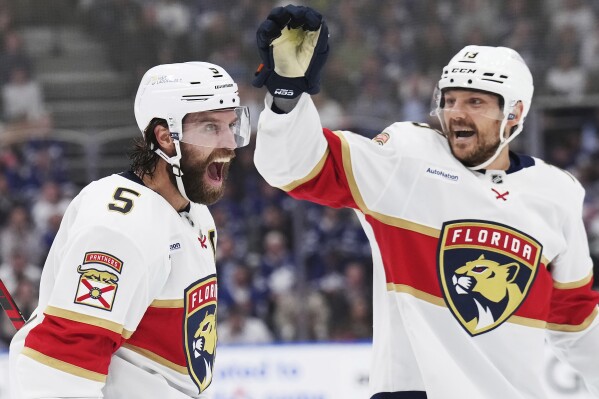 Florida Panthers' Aaron Ekblad (5) celebrates his goal against the Toronto Maple Leafs with Sam Reinhart (13) during first period NHL playoff hockey action in Toronto on Wednesday, May 14, 2025. (Nathan Denette/The Canadian Press via AP)
