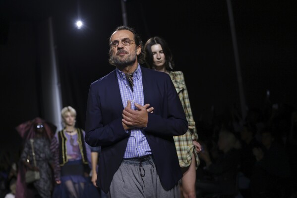 Andreas Kronthaler accepts applause after the conclusion of the Andreas Kronthaler For Vivienne Westwood Spring/Summer 2024 womenswear fashion collection presented Saturday, Sept. 30, 2023 in Paris. (AP Photo/Vianney Le Caer)