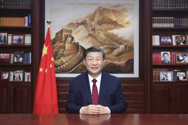 In this photo released on Sunday, Dec. 31, 2023 by Xinhua News Agency, Chinese President Xi Jinping delivers a New Year message in Beijing to ring in 2024. (Ju Peng/Xinhua via AP)