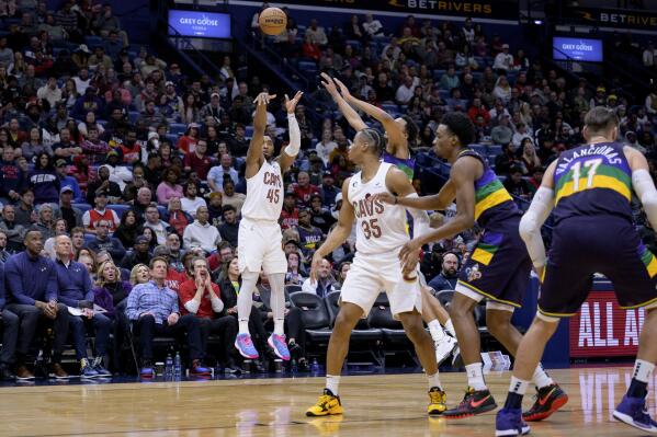 Cleveland Cavaliers guard Donovan Mitchell (45) shoots a 3-pointer against the New Orleans Pelicans during the second half of an NBA basketball game in New Orleans, Friday, Feb. 10, 2023. (AP Photo/Matthew Hinton)