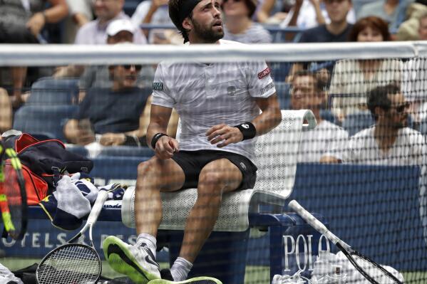 FILE - Nikoloz Basilashvili, of Georgia, checks the scoreboard during a break in play between games against Rafael Nadal, of Spain, during the fourth round of the U.S. Open tennis tournament, Sunday, Sept. 2, 2018, in New York. Basilashvili has been acquitted of domestic violence charges in his home country of Georgia in a case involving his former wife. In a statement emailed to reporters Tuesday, Oct. 25, 2022, by his management company, Basilashvili called the ruling in Tbilisi City Court after a two-year trial "such relief for me, my family and my friends and supporters.” (AP Photo/Carolyn Kaster, File)