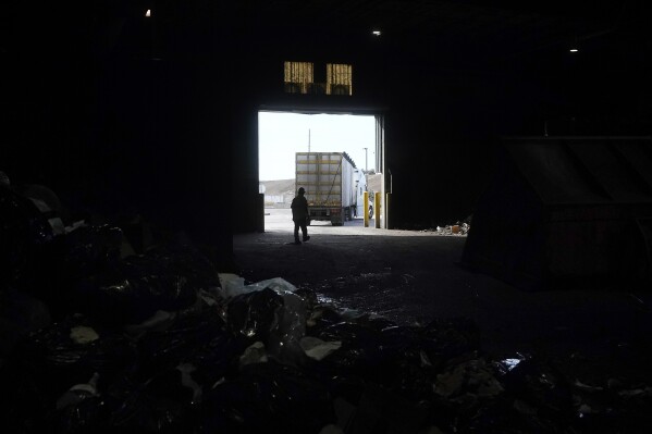 CORRECTS NAME OF FACILITY TO GREENWASTE RENEWABLE ENERGY DIGESTION FACILITY FROM GREENWASTE ZANKER RESOURCE RECOVERY FACILITY - A truck backs into GreenWaste Renewable Energy Digestion Facility to load organic material in San Jose, Calif., Friday, Oct. 27, 2023. A pair of recent reports from the EPA put striking numbers to the problem of food waste: one-third of the food produced in the U.S. is never eaten. California began requiring every jurisdiction to provide organic waste collection services starting in 2022. (AP Photo/Jeff Chiu)