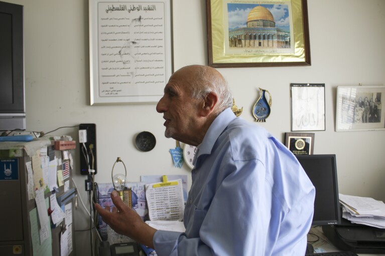 Dawud Assad, 92, stands in front of Palestinian decor in his home in Monroe Township, N.J., on May 11, 2024. (AP Photo/Noreen Nasir)