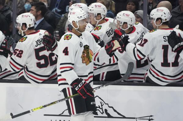 Chicago Blackhawks defenseman Seth Jones (4) greets teammates after he scored a goal against the Seattle Kraken during the first period of an NHL hockey game, Wednesday, Nov. 17, 2021, in Seattle. (AP Photo/Ted S. Warren)