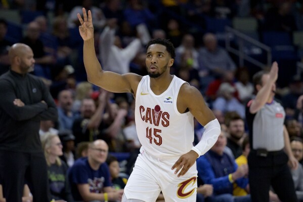 Cleveland Cavaliers guard Donovan Mitchell (45) celebrates a three point basket during the first half of an NBA basketball game against the New Orleans Pelicans in New Orleans, Wednesday, March 13, 2024. (AP Photo/Matthew Hinton)