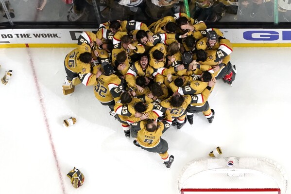 Members of the Vegas Golden Knights celebrate after they defeated the Florida Panthers 9-3 to win the Stanley Cup in Game 5 of the NHL hockey Stanley Cup Finals Tuesday, June 13, 2023, in Las Vegas. (AP Photo/Abbie Parr)