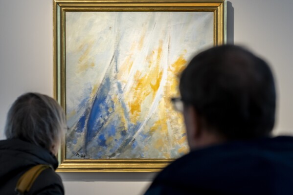 People view a painting by Denmark's Queen Margrethe on display at Bruun Rasmussen Auctions, in Lyngby, Denmark, Monday, Feb. 12, 2024. The artwork was painted in 1988 and was originally a gift by Queen Margrethe to her then court martial, Hans Soelvhoej. The painting will feature in the Bruun Rasmussen's Live Auction in March. (Ida Marie Odgaard/Ritzau Scanpix via AP)