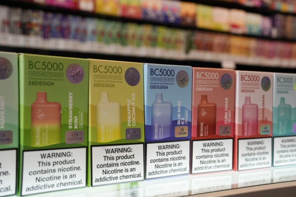 FILE - Varieties of disposable flavored electronic cigarette devices are displayed at a store in Pinecrest, Fla., Monday, June 26, 2023. A judge has found that an Ohio law prohibiting cities from banning the sale of flavored tobacco products is unconstitutional. The state is expected to appeal the ruling issued Friday by Franklin County Common Pleas Court Judge Mark Serrott. (AP Photo/Rebecca Blackwell, File)
