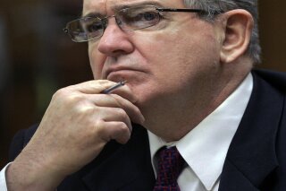 FILE- In this Oct. 15, 2008 file photo, former FBI agent John Connolly listens to the testimony during his trial in Miami. The imprisoned former FBI agent serving a 40-year prison sentence for alerting former Boston mobster Whitey Bulger that he could implicated in a mob murder wants to be released from prison on medical grounds. Connolly will ask the Florida Commission on Offender Review Wednesday, Feb. 17, 2021 to release him. (AP Photo/Alan Diaz, File)