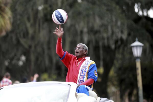 Larry "Gator" Rivers, a member of the Chatham County Commission and a former Harlem Globetrotter, shows off his ball handling skills as he rides in the annual Veterans Day Parade on Thursday, Nov. 11, 2021 in Savannah, Ga. Rivers, who helped integrate high school basketball in Georgia before playing for the Harlem Globetrotters and becoming a county commissioner in his native Savannah, died Saturday, April 29, 2023, at age 73. (Richard Burkhart/Savannah Morning News via AP)
