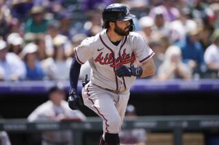 Atlanta Braves' Dansby Swanson heads up the first-base line after hitting a single off Colorado Rockies starting pitcher Ryan Feltner in the second inning of a baseball game, Sunday, June 5, 2022, in Denver. (AP Photo/David Zalubowski)