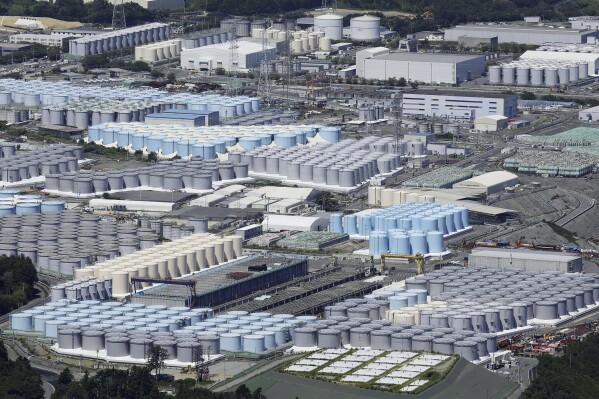 This aerial view shows the tanks containing treated radioactive wastewater at the Fukushima Daiichi nuclear power plant in Fukushima, northern Japan, on Aug. 22, 2023. The operator of the tsunami-wrecked Fukushima Daiichi nuclear power plant will begin releasing the first batch of treated and diluted radioactive wastewater into the Pacific Ocean later Thursday, Aug. 24, 2023, utility executives said. (Kyodo News via AP)