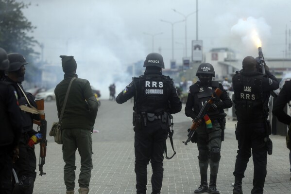 FILE - Police officers disperse protesters with tear gas following a demonstration at Lekki Toll plaza in Lagos, Nigeria, on Oct. 20, 2021. Authorities in Nigeria say more than 100 people who died in 2020 during protests against police brutality will soon be buried. The burial plans were announced by the Lagos State Ministry of Health after local media broke the news, prompting criticism from rights groups and activists who demanded a new investigation of the killings. (AP Photo/Sunday Alamba, File)
