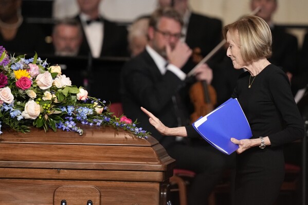 Judy Woodruff pauses at the casket after speaking at a tribute service for former first lady Rosalynn Carter at Glenn Memorial Church at Emory University on Tuesday, Nov. 28, 2023, in Atlanta. (AP Photo/Brynn Anderson, Pool)