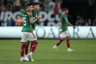 Mexico's Johan Vazquez, left, and Mexico's Edson Alvarez embrace after defeating Jamaica in a CONCACAF Gold Cup semifinals soccer match Wednesday, July 12, 2023, in Las Vegas. (AP Photo/John Locher)