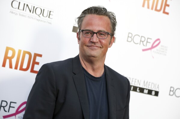 FILE - Matthew Perry arrives at the premiere of "Ride" at The Arclight Hollywood Theater in Los Angeles. Perry, who starred as Chandler Bing in the hit series "Friends," has died. He was 54. The Emmy-nominated actor was found dead of an apparent drowning at his Los Angeles home on Saturday, according to the Los Angeles Times and celebrity website TMZ, which was the first to report the news. Both outlets cited unnamed sources confirming Perry's death. His publicists and other representatives did not immediately return messages seeking comment. (Photo by Rich Fury/Invision/AP, File)